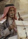 Little Petra, Jordan Ã¢â¬â June 20, 2017: Old Bedouin man or Arab man in traditional outfit, playing his musical instrument .